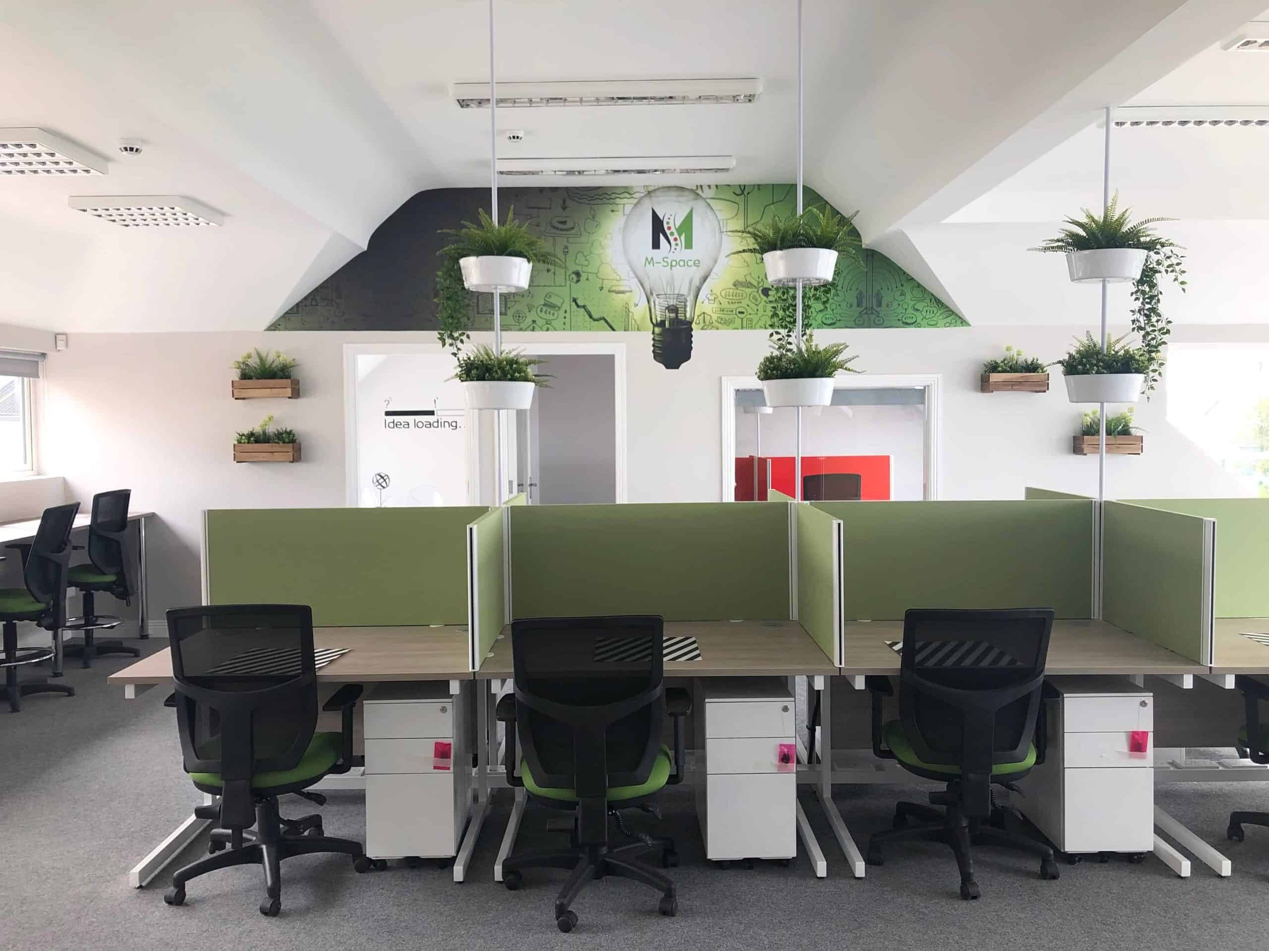 A Photo from coworking space and virtual office Mspace malahide. The photo shows multiple empty desks and work stations in a bright white and green environment paired with lush plants and the iconic green MSpace Light Bulb painted on the far wall. MSpace is a coworking space or virtual office that is perfect for remote work as it allows workers to leave their home office for a second office Virtual Office Free Trial Webinar Moderator Webinar Hosting Costs Digital Nomad Tools Join A Webinar Businesses Use Webinars For The Following Reasons Except Seminar And Webinar Difference Online Co Working Space Seminar Vs Webinar Online Co-working Spaces metaverse meetings Cost of webinar How to Create a Virtual Office Networking At A Webinar Set Up Virtual Office Virtual Co Working Space Online Webinar Audio Review Remote Collaboration Tools Online Meeting Tools Metaverse Meeting Platform Remote Work Office Virtual Conferences and Events Host Better Webinars Remote Work Solutions Virtual Networking Platform Hosting A Webinar Remote Team Building